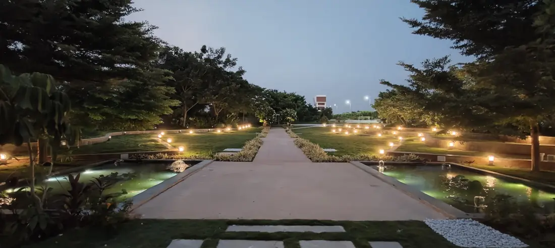 Landscaped water features and lit pathways at Eden 144