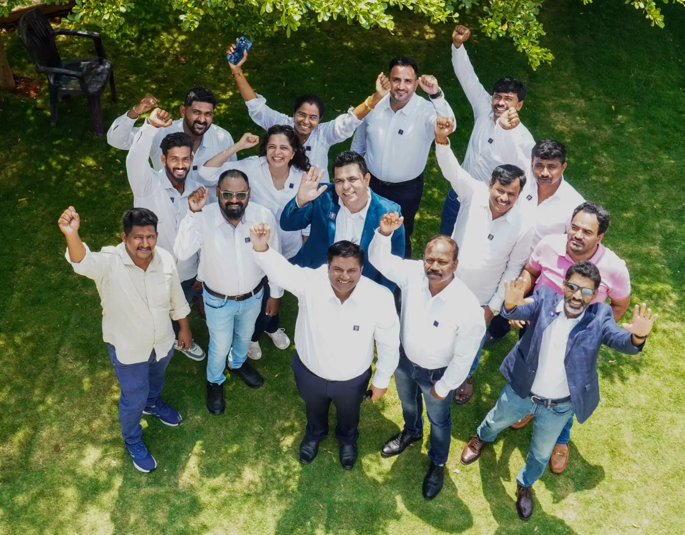 The One Wolf team together in a garden, arms raised