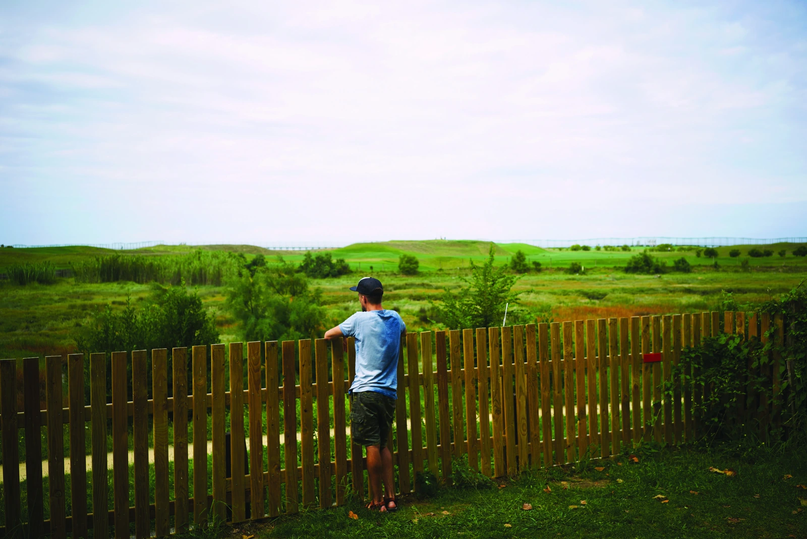 A resident at the fence line of a fully fenced private farm house at Northern County